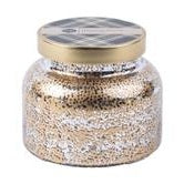A mercury glass jar candle with a gold lid on a white background