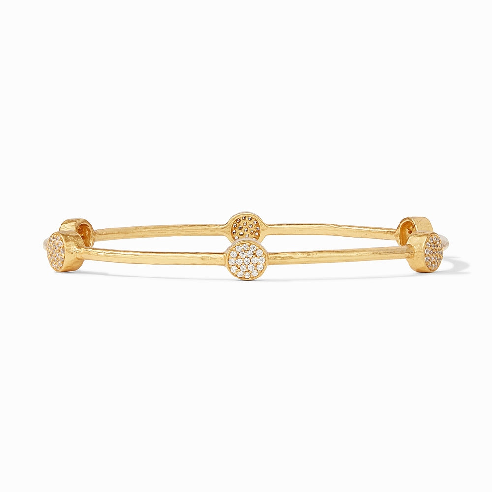 Gold bangle bracelet with four circular stations featuring pave set white stones