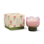 Pink tulip shaped candle in a decorative holder with a matching floral box on a white background