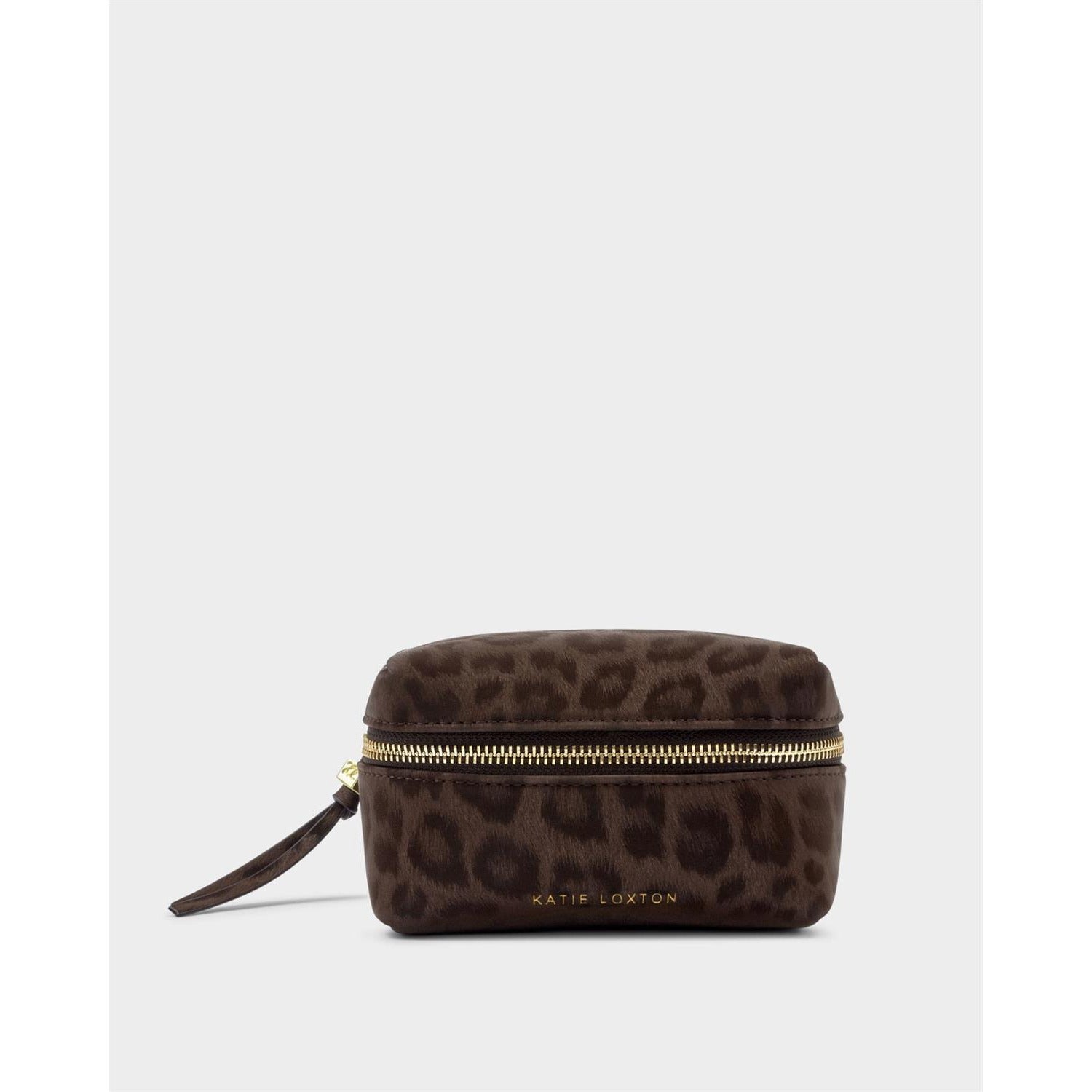 Product photograph by Katie Loxton of a dark brown leopard print makeup bag featuring a gold-toned wraparound zipper and an embossed brand logo set against a neutral studio backdrop