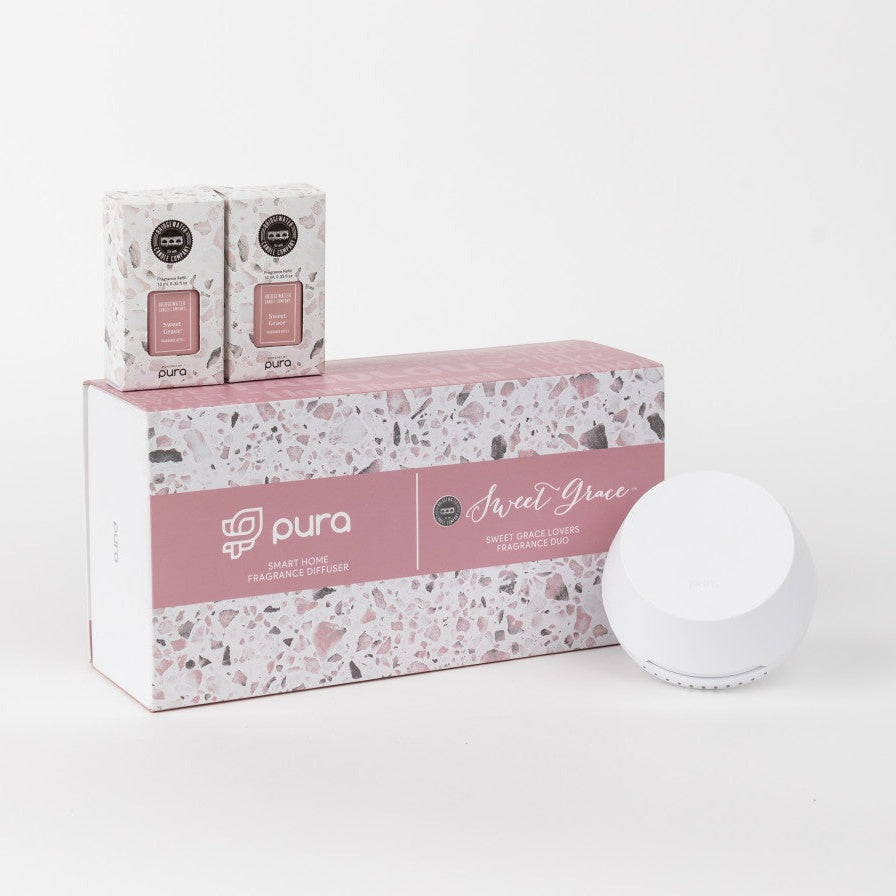 A Pura smart home fragrance diffuser set with two Sweet Grace fragrance vials and a white diffuser device, all presented on a box with a floral pattern.