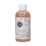 Bottle of Sweet Grace laundry detergent with a white cap and pink and grey patterned label