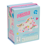 Product photography by Floss & Rock of a unicorn-themed shaped puzzle box for kids featuring a whimsical unicorn, rainbow, and butterfly, including shiny foil accents and a pink striped rope handle against a white background