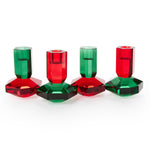 Red and green crystal taper candleholders in a row