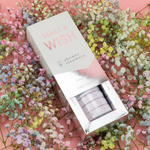 "Make a Wish" shower steamers box slid open to show lavender steamers, lying on pastel baby's breath
