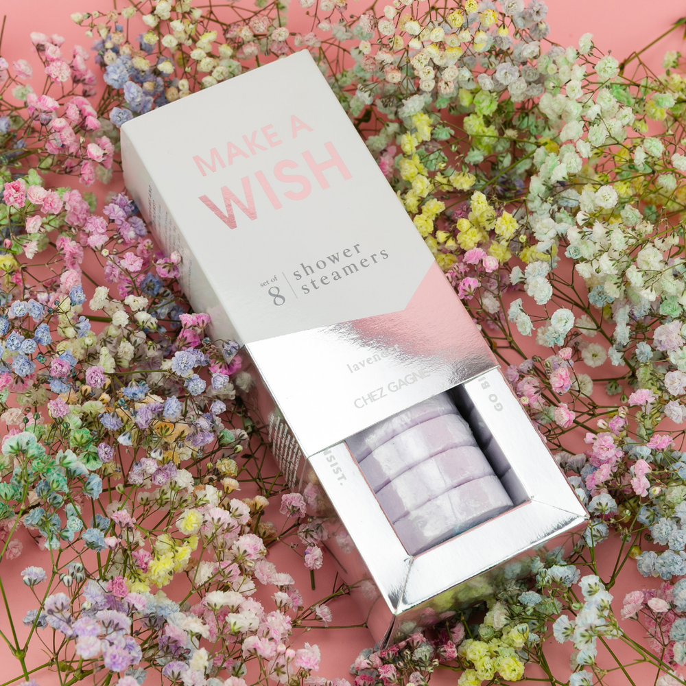 "Make a Wish" shower steamers box slid open to show lavender steamers, lying on pastel baby's breath