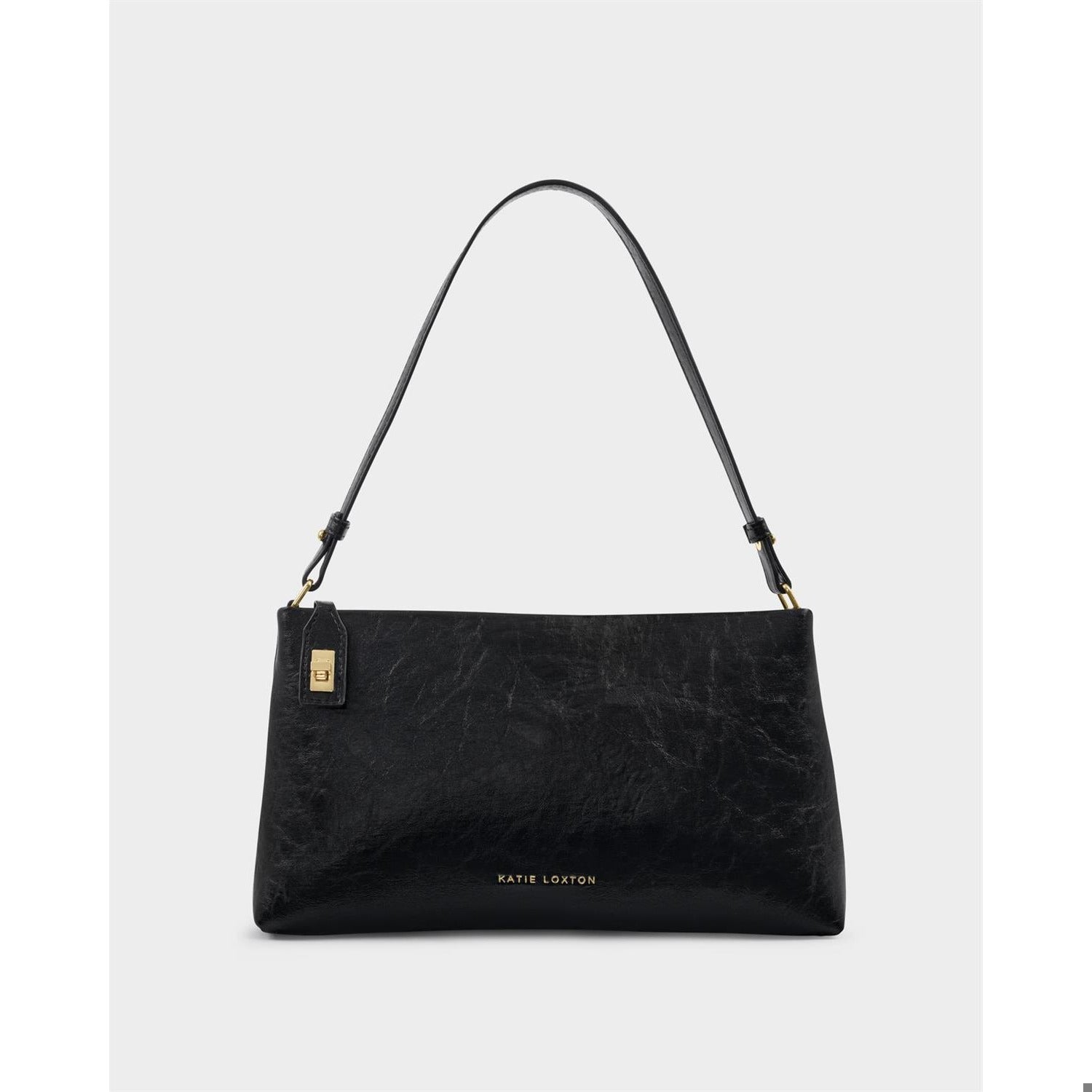 Katie Loxton black vegan leather shoulder bag showcased against a light grey studio background featuring a textured crinkled finish and polished gold-tone hardware including a logo-engraved plaque and a small lock-shaped charm tag