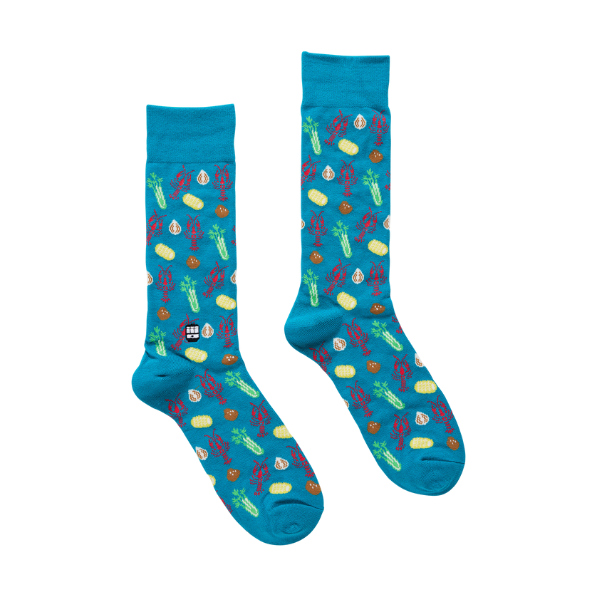 Pair of blue socks with colorful patterns on a white background