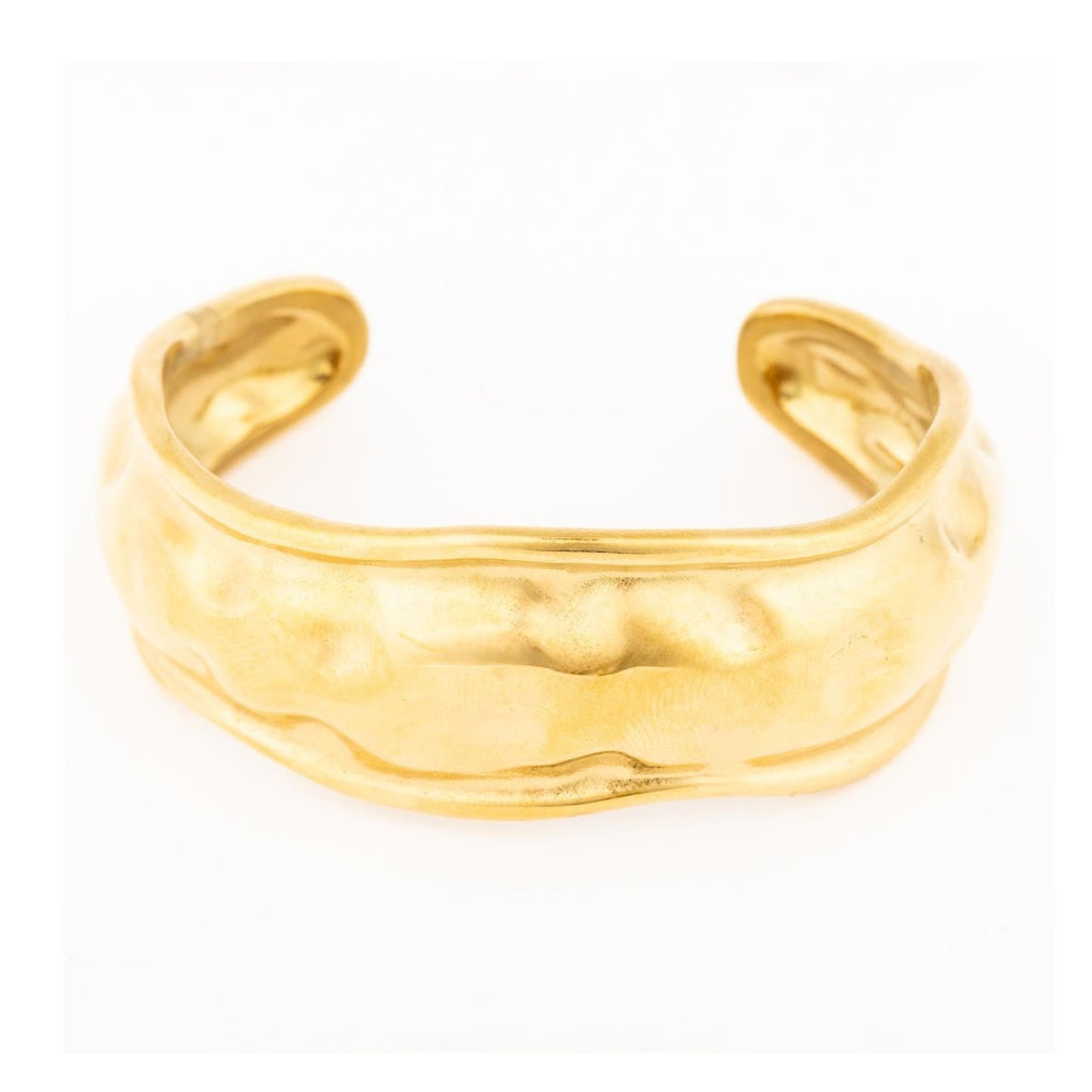 Gold cuff bracelet with a textured wavy surface