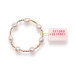 Pearl bracelet with colorful beads next to a 'Beaded Blondes' box on a white background