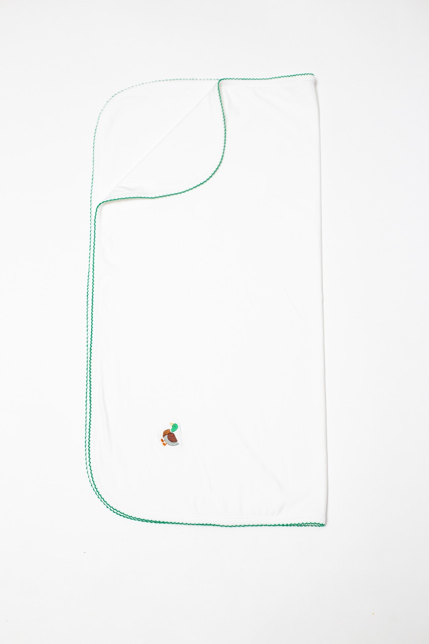 White towel with a duck design and green trim on a white background