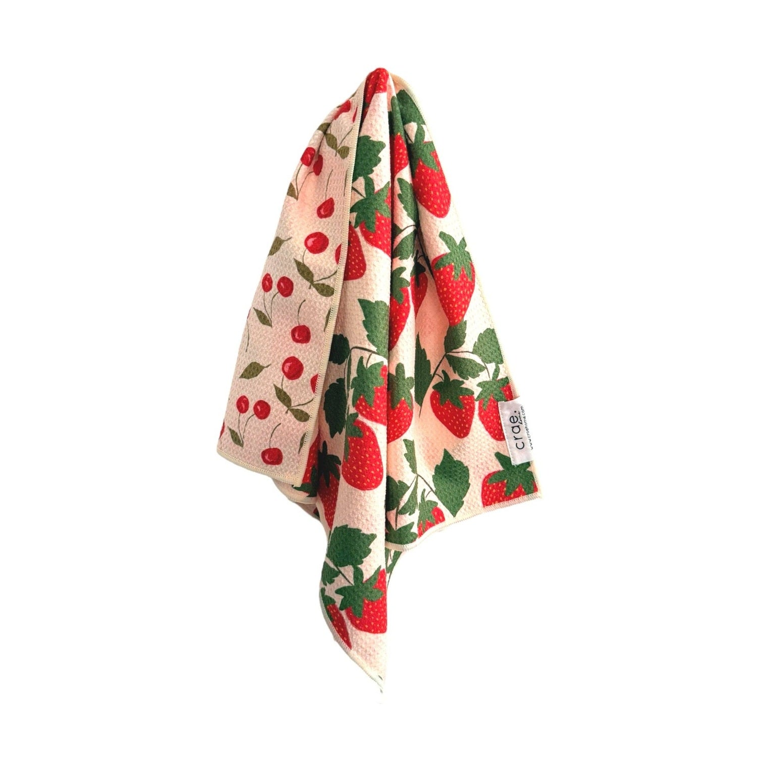 Floral patterned towel with red flowers and green leaves on a white background