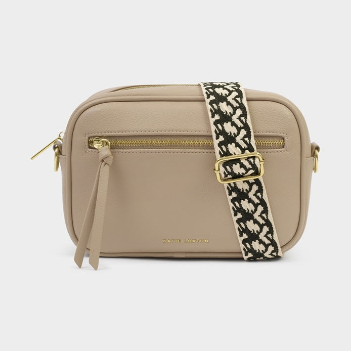 Beige camera bag shaped purse with a patterned strap on a light gray background