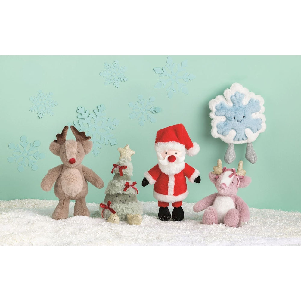 Plush reindeer Christmas tree Santa and snowflake characters on a snowy surface