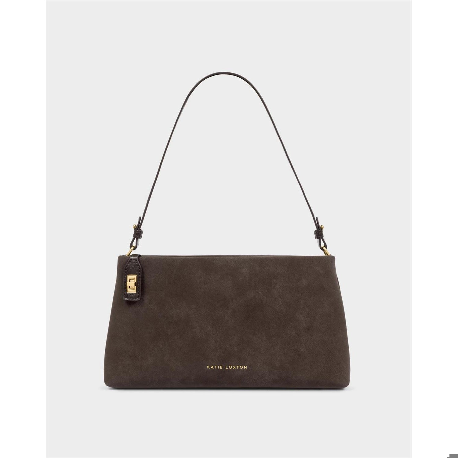 Vegan suede handbag by Katie Loxton featuring a chocolate brown rectangular silhouette with an adjustable thin strap and gold-tone metal hardware against a neutral grey background