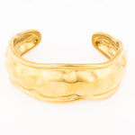 Gold cuff bracelet with a textured hammered finish