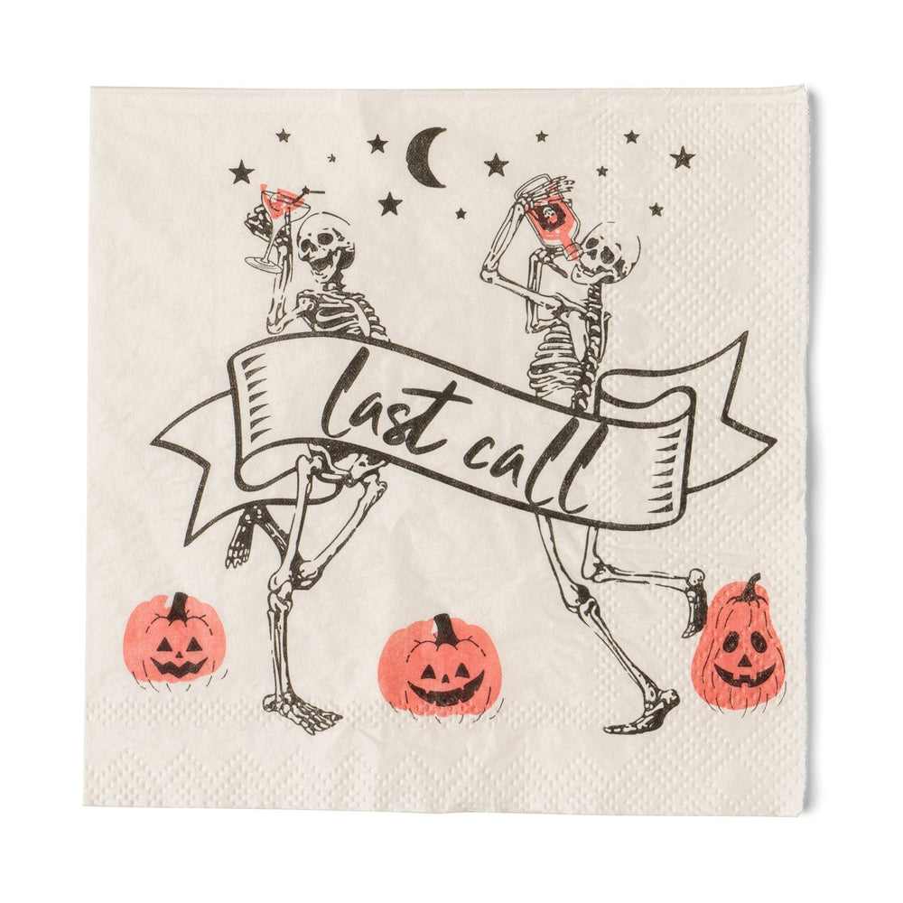 Cream cocktail napkin with two dancing skeletons holding drinks, a "last call" banner and jack-o'-lanterns
