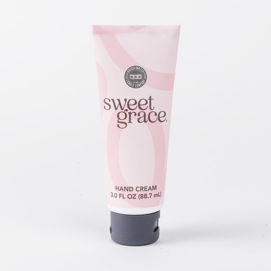 Pink tube of sweet grace hand cream on a white background