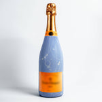 Bottle with a blue label and gold cap on a white background