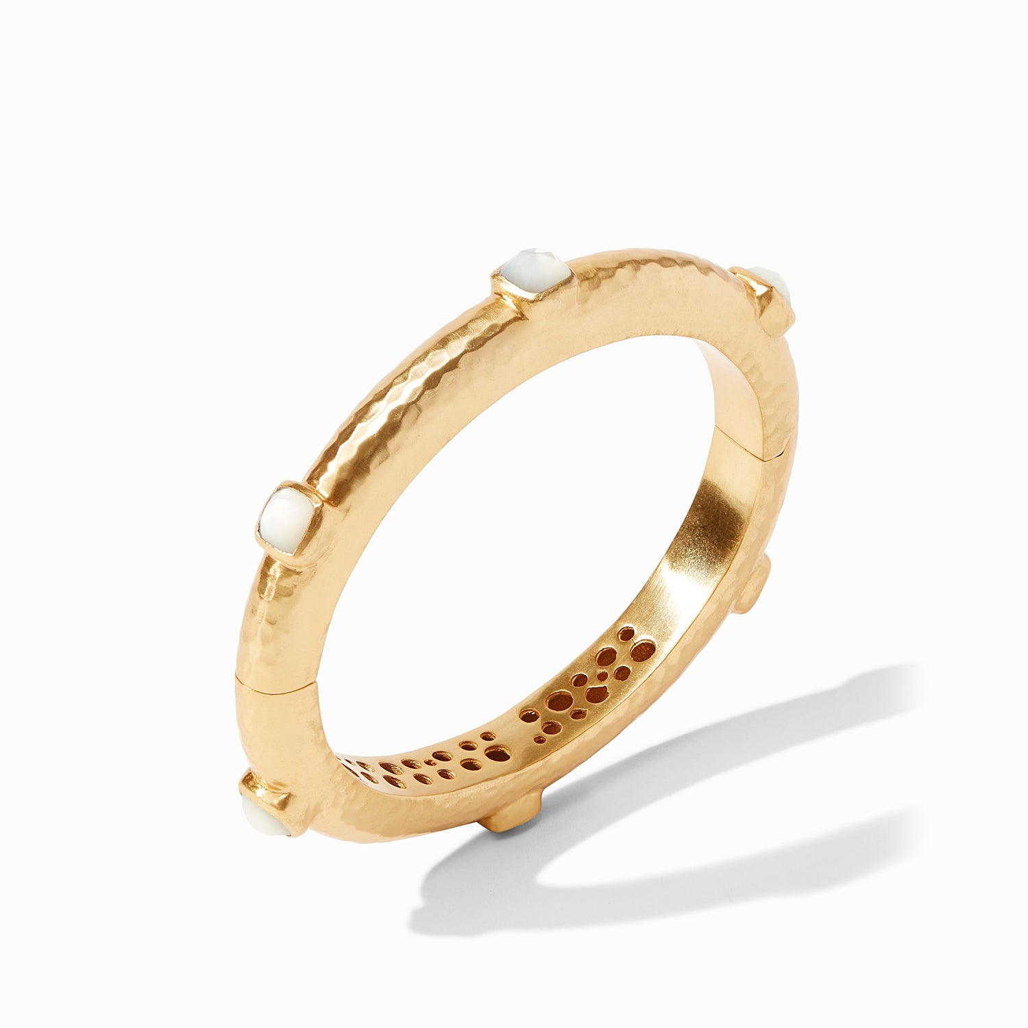 Gold hinged bangle bracelet with a hammered texture and small white stone accents