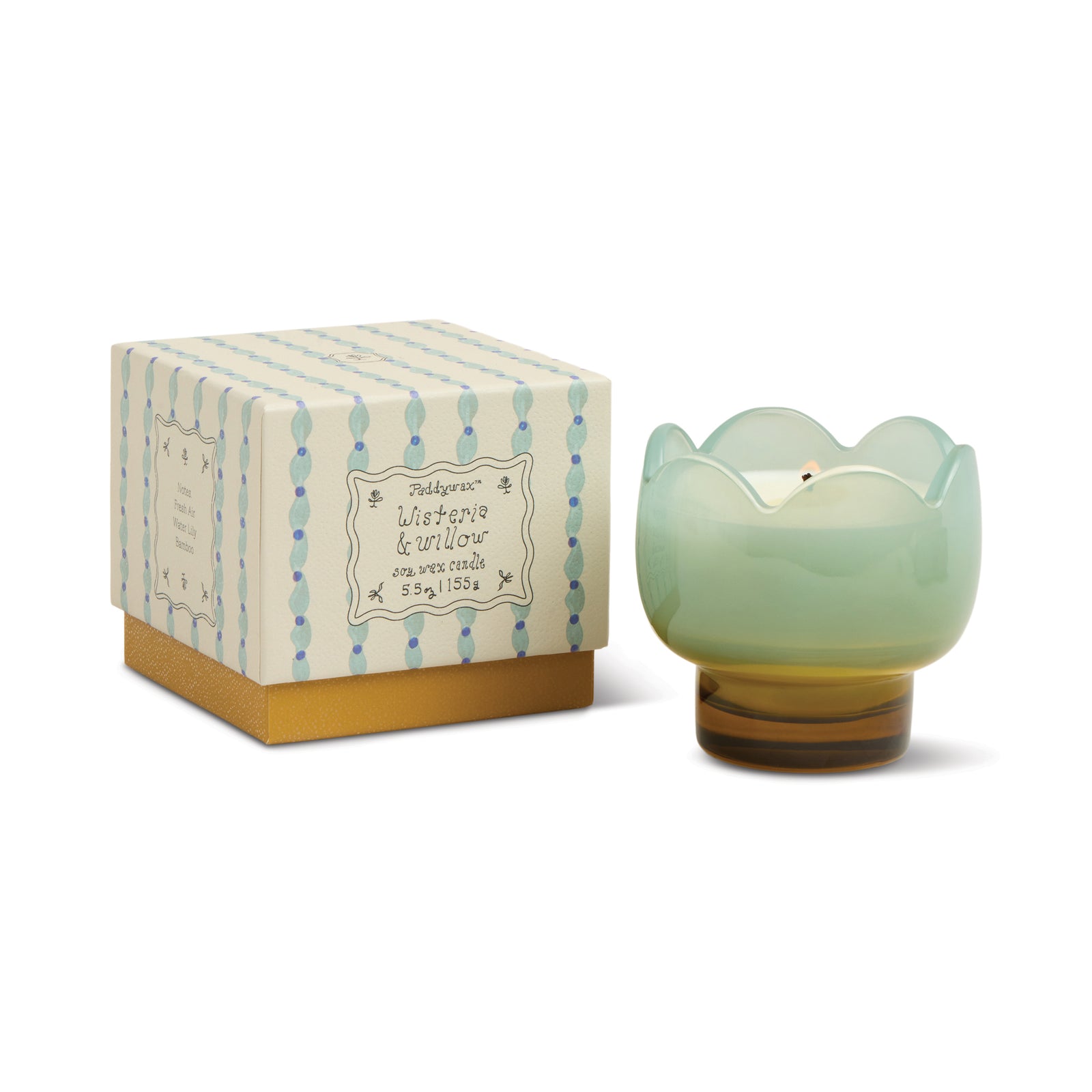 Green tulip shaped candle in a decorative holder with a matching box on a white background