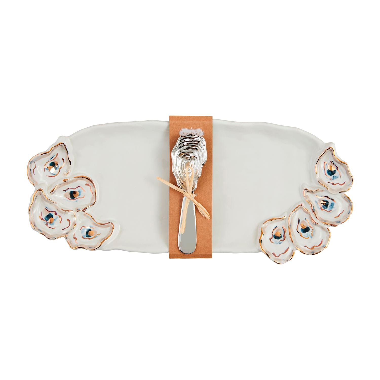 Ceramic oyster platter set by Mud Pie featuring a white serving tray with gold-rimmed shell reliefs, blue watercolor accents, and a silver shell-shaped spreader tied with a raffia bow on a white background