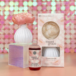 Flower diffuser with an oil refill and its box on a sequin background