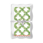 White rectangular ceramic tray with a green wreath pattern napkin tied with a white ribbon
