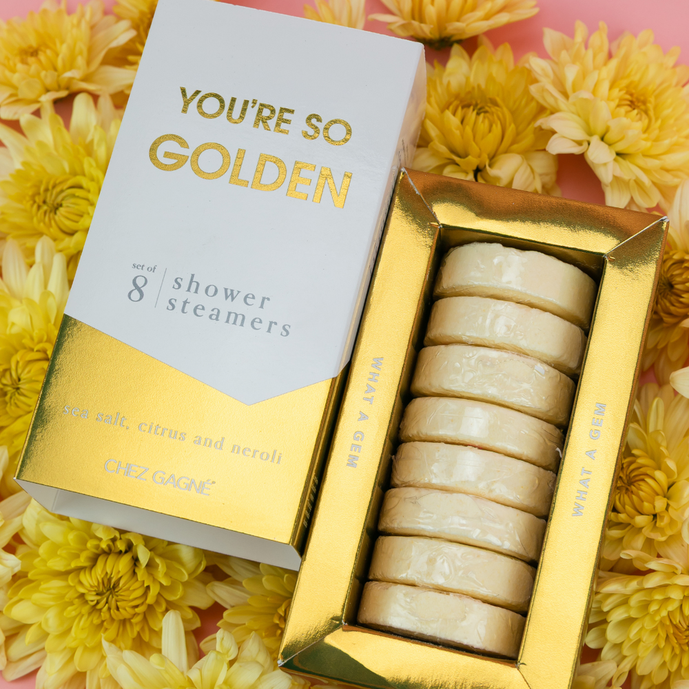 "You're So Golden" shower steamers box slid open to show cream steamers, lying on yellow flowers