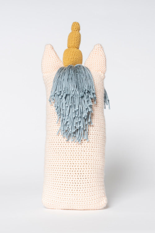 Crocheted unicorn with pointed pale pink ears, a segmented gold horn, and a fringed light blue yarn mane