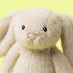 Close-up of a plush bunny toy with a yellow background