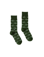 Knit cotton socks by Lacoste featuring a pair of dark green crew socks against a black backdrop with an all-over light green crocodile print, ribbed cuffs, and a small white tram detail on the left sock