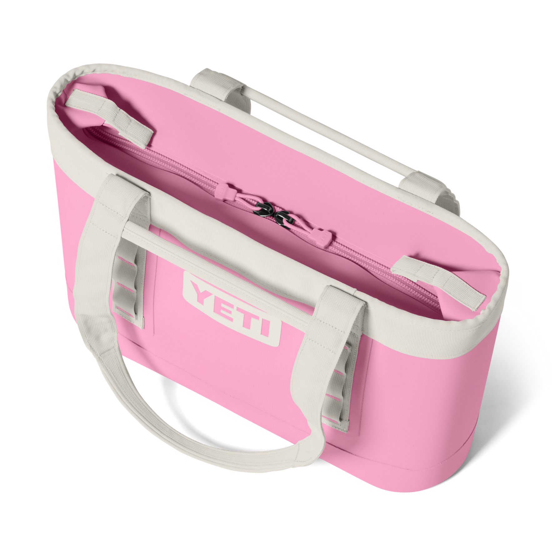 Pink YETI tote bag with white handles on a white background
