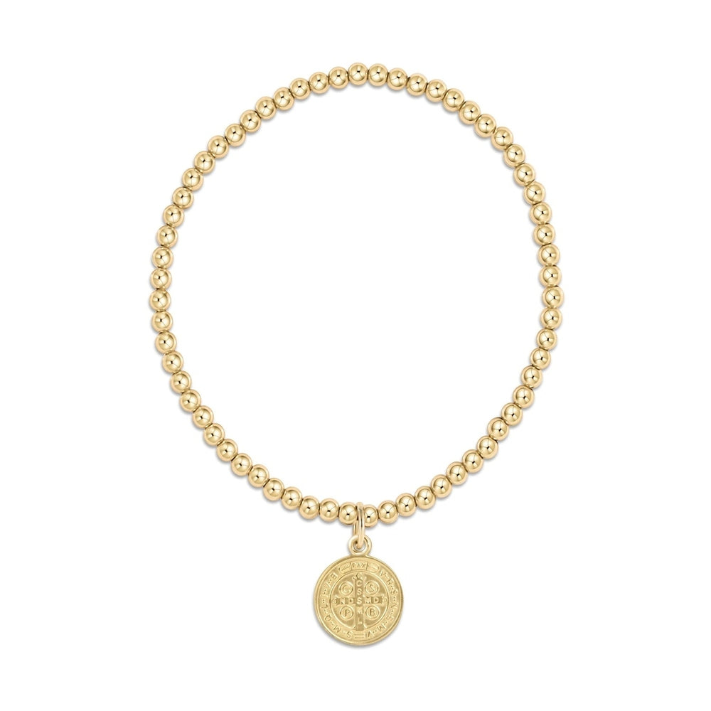 Gold beaded stretch bracelet with a round Saint Benedict medal charm