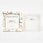 Aroma Avenue candle packaging with a white candle on a light gray background