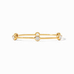 Gold and diamond bangle centered on a white background featuring a hammered yellow gold texture and sparkling bezel-set round stones along a minimalist thin band