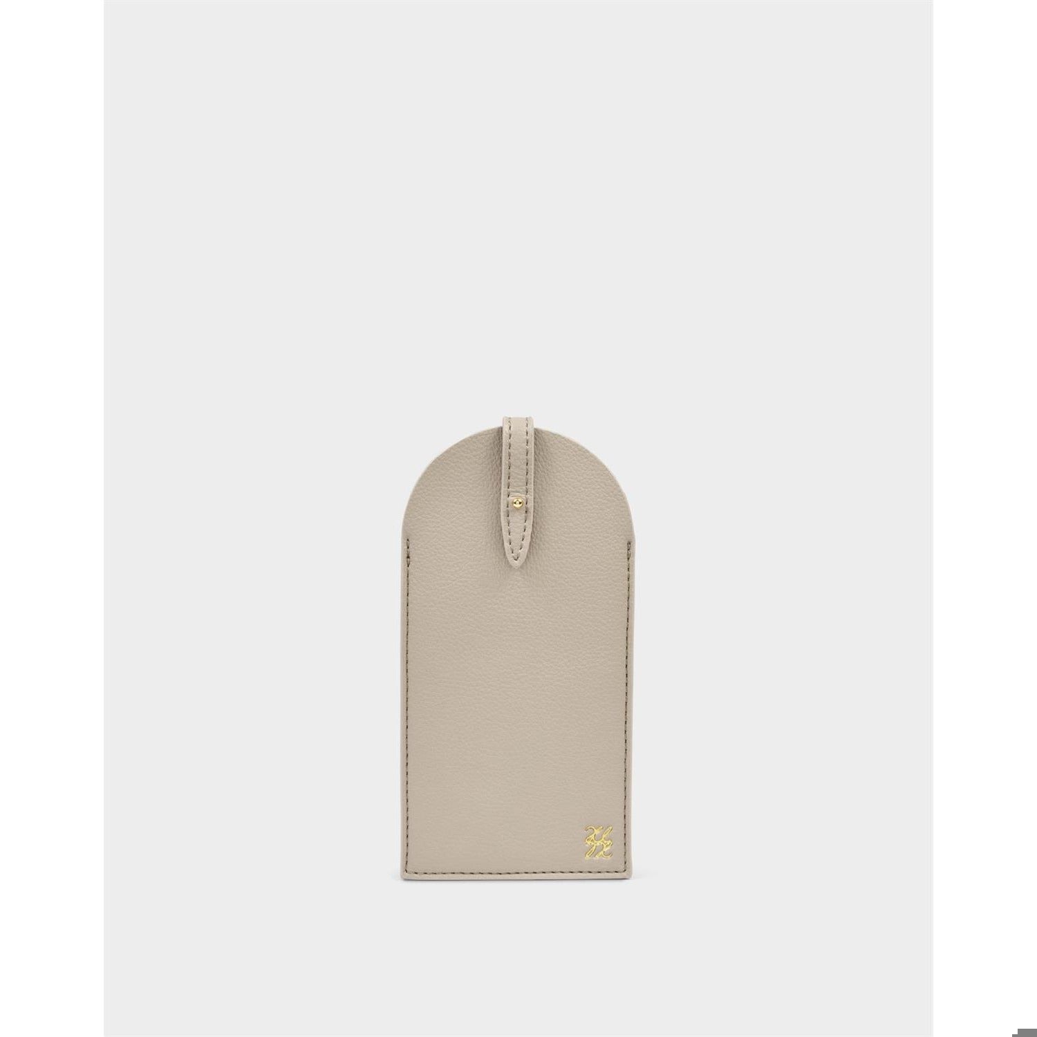 Pebble-grain leather accessory by an unknown designer featuring a taupe finish, visible tonal perimeter stitching, and a small gold-tone metallic logo emblem at the bottom corner against a neutral studio background