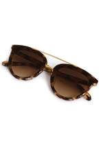 Sunglasses with brown lenses and gold frame on a white background