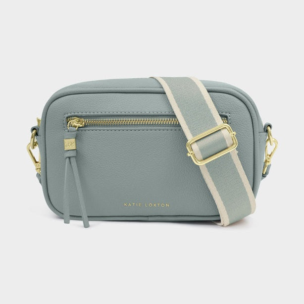 Gray crossbody bag with gold accents on a white background