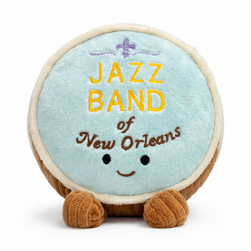 Plush toy shaped like a bass drum with 'Jazz Band of New Orleans' text on a white background