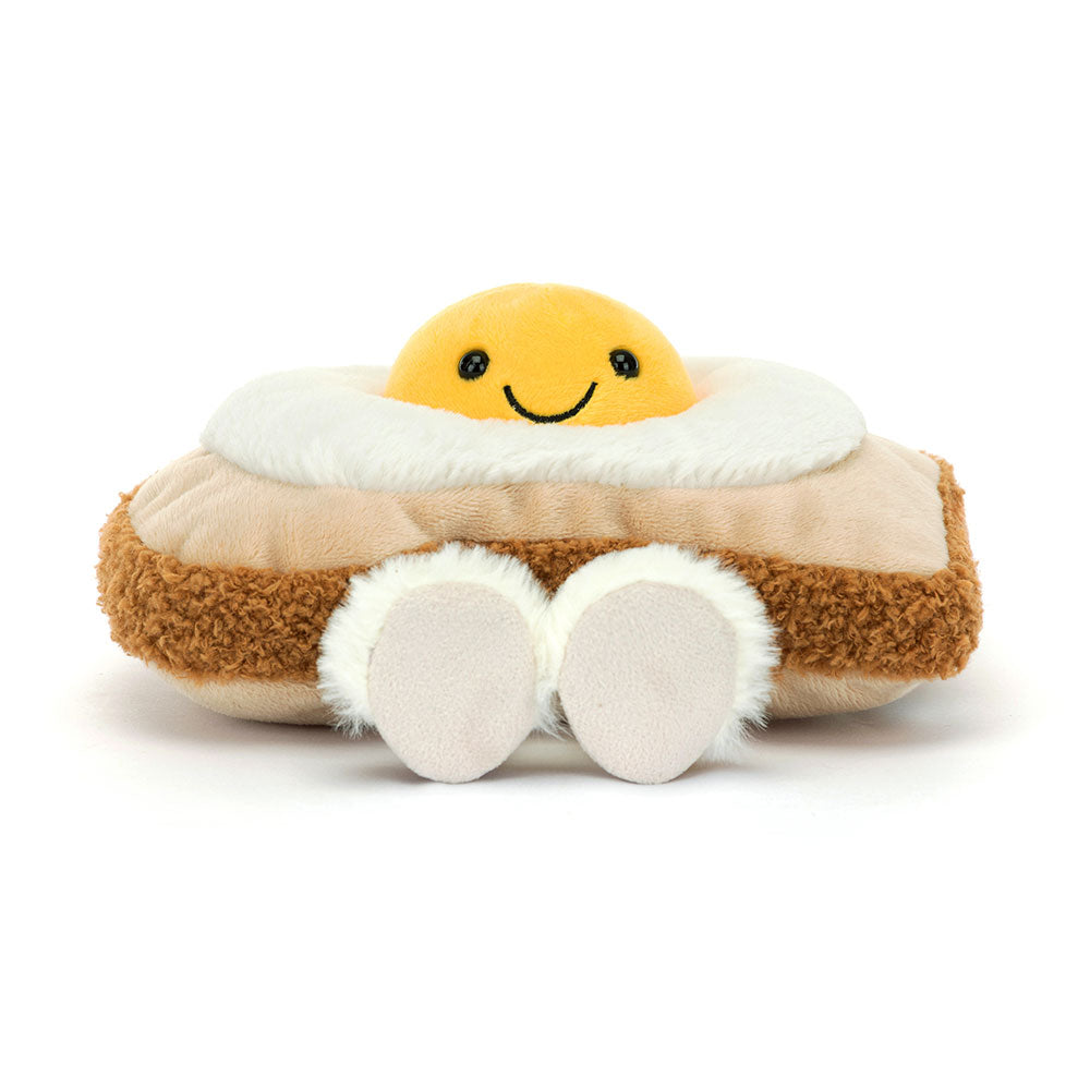 Plush fried egg on toast with a smiling yolk face and fluffy white feet