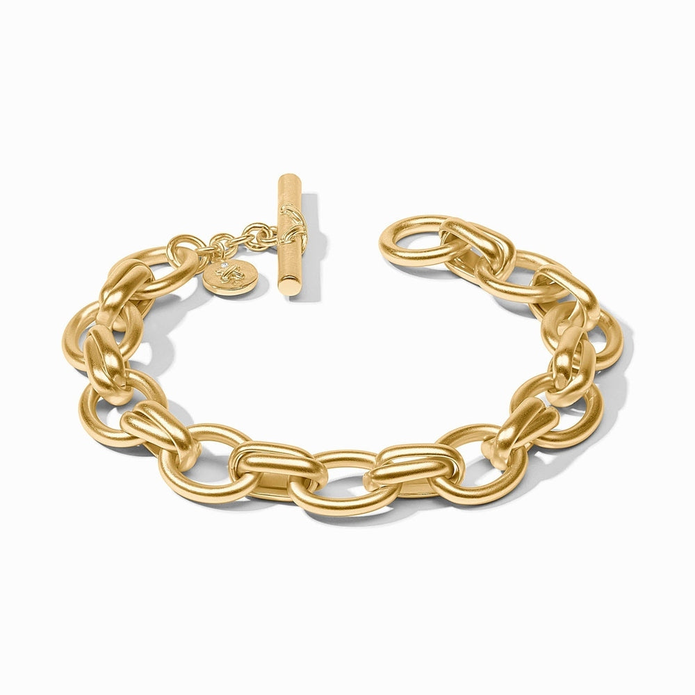 Gold chain link bracelet with a toggle clasp and small round charm