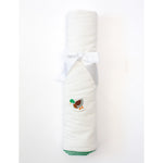 White towel with a duck design and green trim on a white background