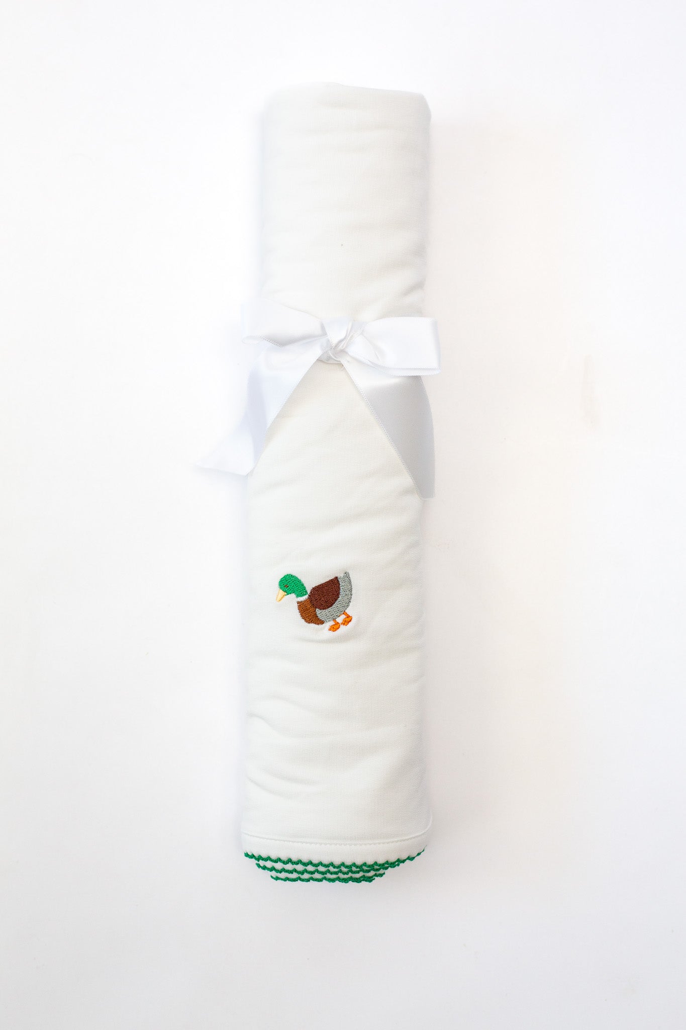 White towel with a duck design and green trim on a white background