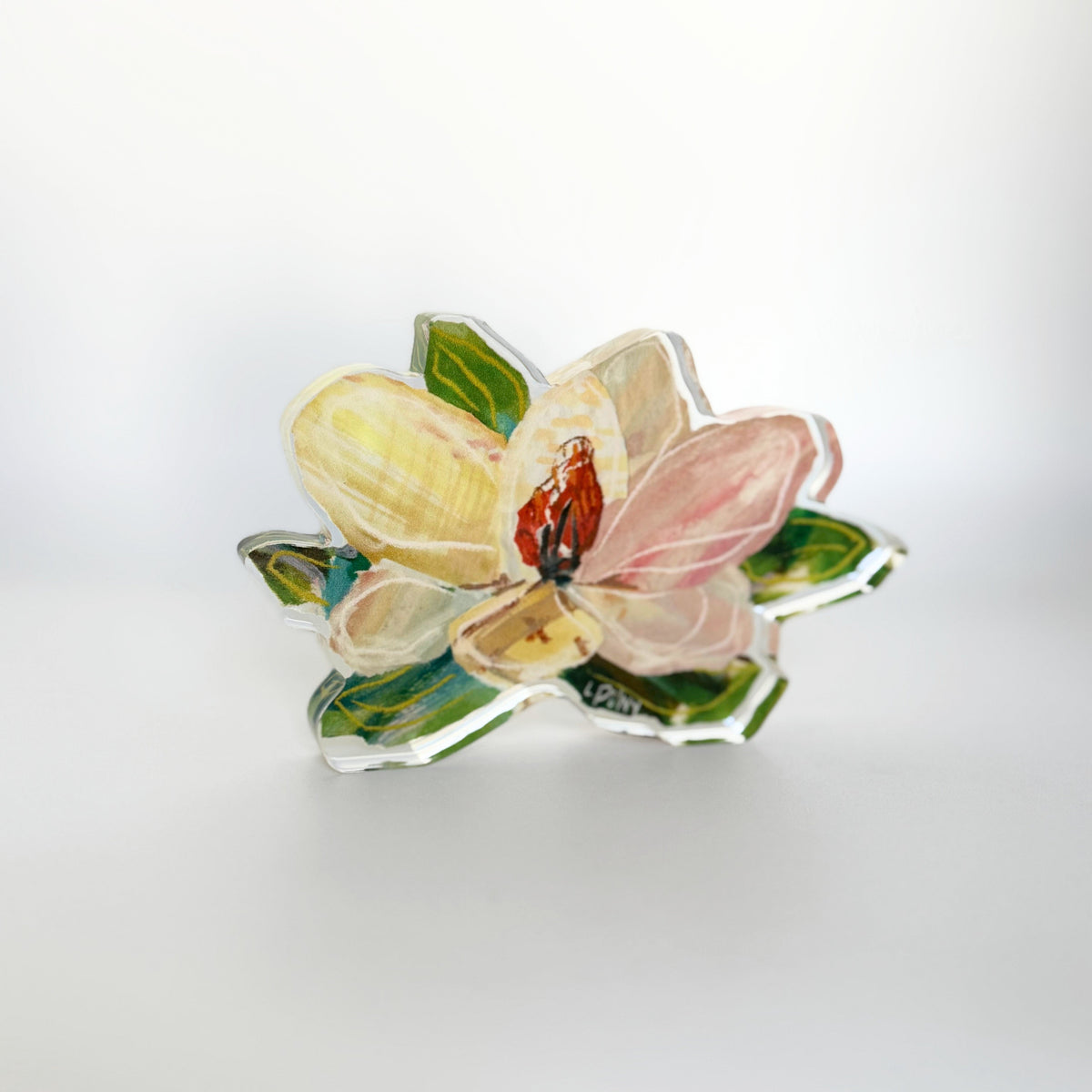 Painted acrylic magnolia bloom block at an angle