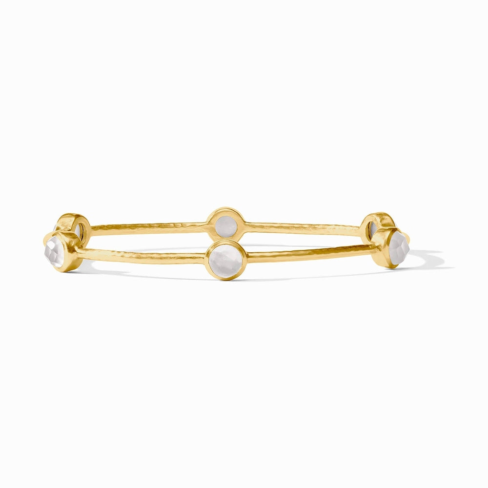 Gold bangle bracelet with four round white stone settings