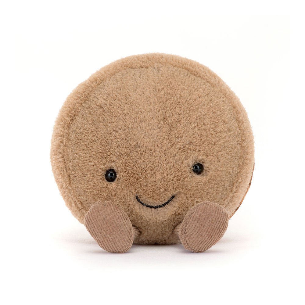 Tan plush macaron with a smiling face and brown corduroy feet, front view