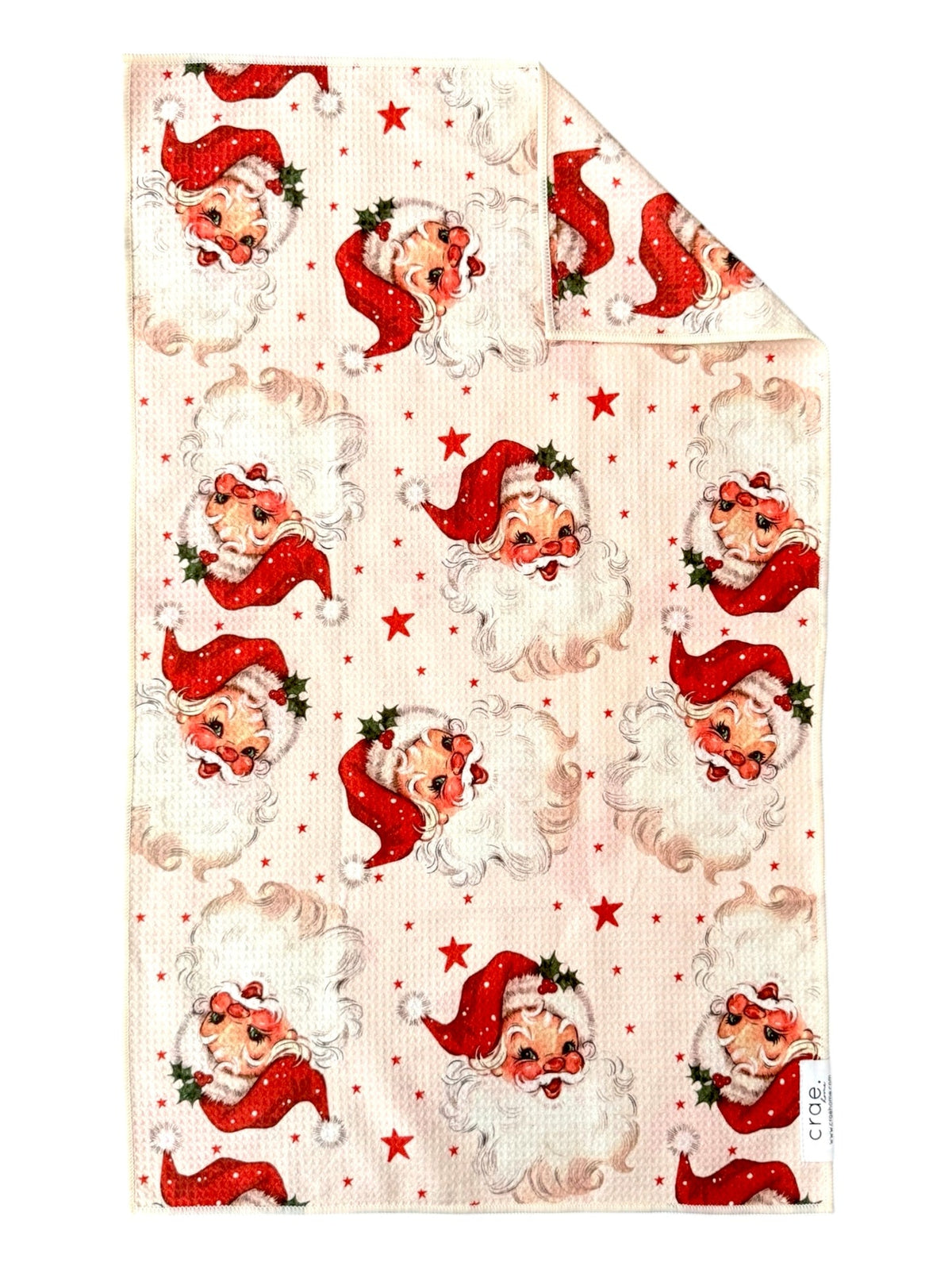 Cream hand towel printed with vintage Santa faces and red stars