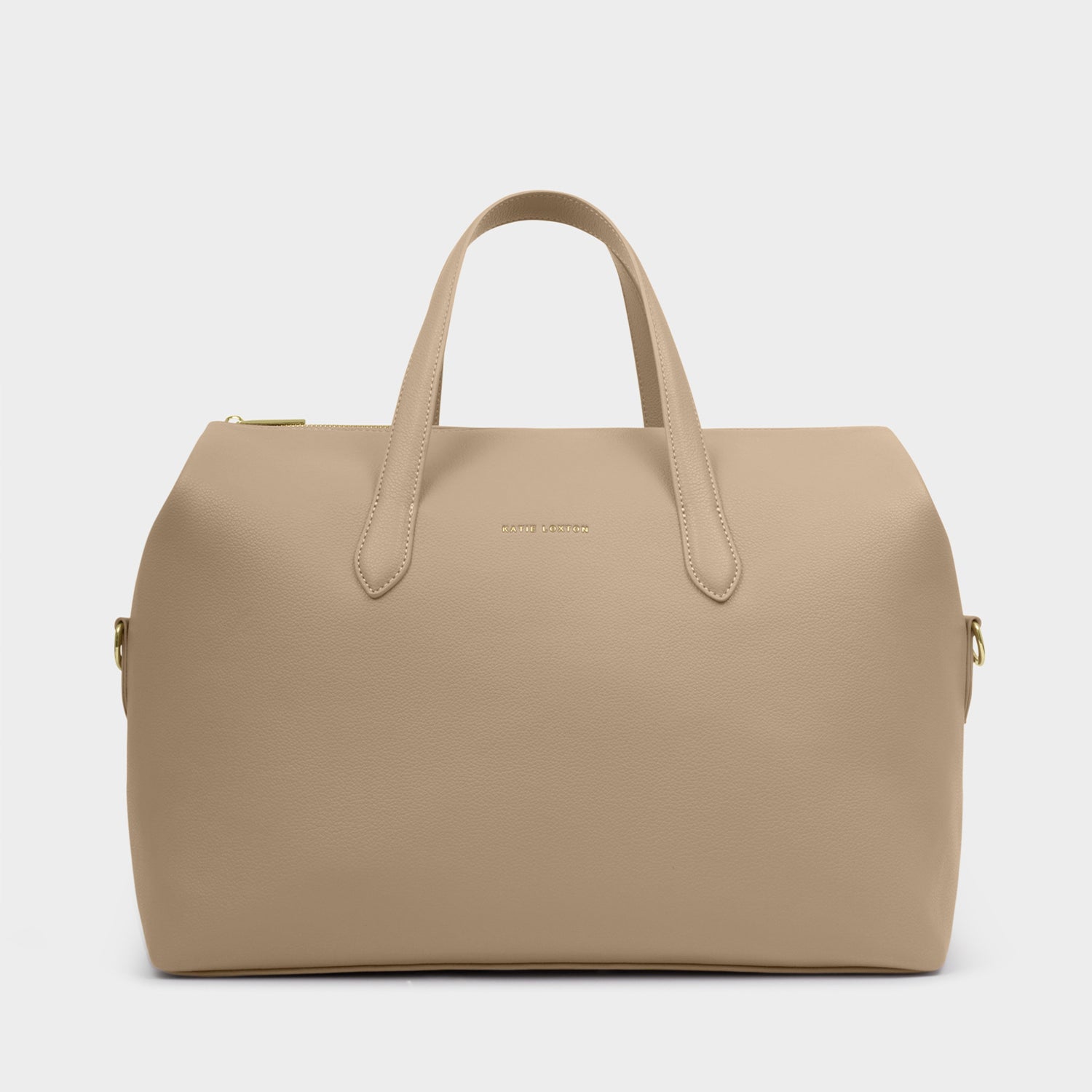 Product photograph by Katie Loxton of a taupe vegan leather weekend bag on a plain grey background featuring a gold-stamped brand logo and matching top handles with metallic hardware accents