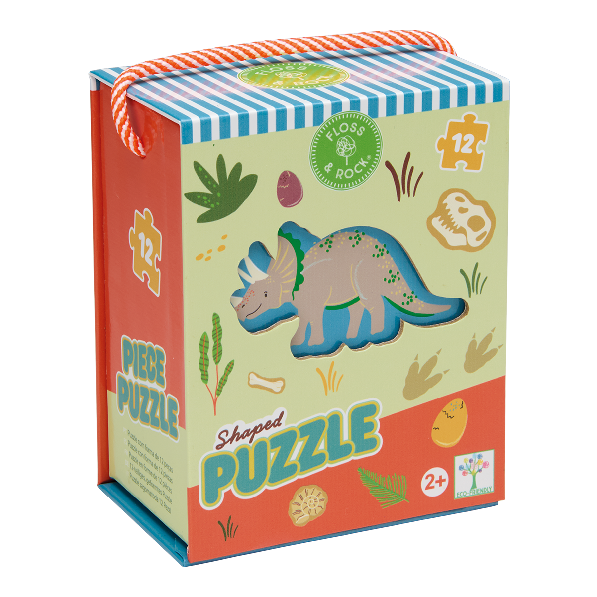 Illustrated puzzle box by Floss & Rock featuring a triceratops dinosaur in a prehistoric landscape with colorful dinosaur footprints, a fossilized ammonite, and a vibrant orange-and-white braided rope handle